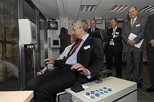 Veolia's worldwide chief executive Denis Gasquet uses an electronic chair to feed waste into the incinerator