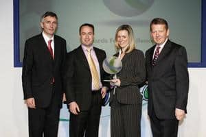 Kelly Reynolds of Manchester city council, receives the trophy from Martin Green of UPM, with, right, Bill Turnbull and, left, Steve Eminton