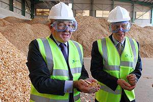 Energy minister Malcolm Wicks (left) inspects wood fuel ready for the Wilton 10 power plant, with Sembcorp project director Tony Lewis