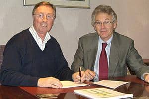Ray Mann (left) with David Burton of CRT Recycling signing the agreement