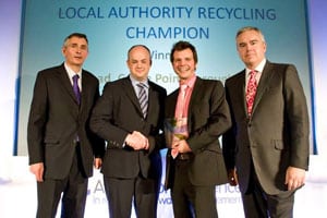 Tim Read (second right) receives his 2010 Recycling Champion Award from Craig Robinson, head of sourcing of recovered paper at UPM while Steve Eminton, editor of letsrecycle.com (left), and Awards host Huw Edwards (right) look on
