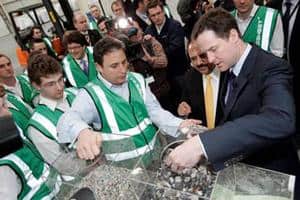 2K Manufacturing chief executive Omer Kutluoglu (second left) shows Liberal Democrats leader Nick Clegg waste plastic set to be turned into EcoSheets