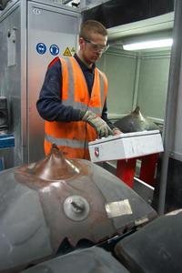A Yorwaste employee prepares cathode ray tubes from old televisions to be cut by the new CRT cutting machine at Hessay