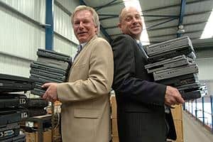 Peter Hunt (left) of WasteCare and Tim Reay of Yorwaste, carrying laptop computers waiting to be recycled in Yorkshire