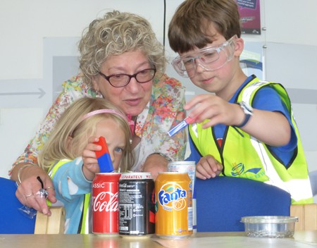 Ruby and Stanley Viner working out whether the fizzy drinks cans are in aluminium or steel