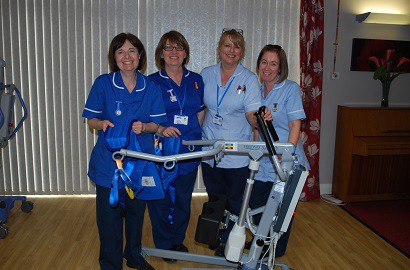 Staff at St Ann's Hospice, with the new winch, purchased through Salford's recycling rewards scheme