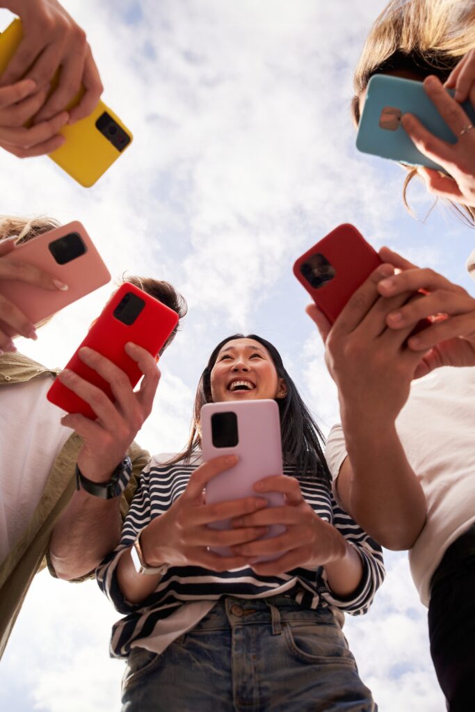 Friends holding cellphones mobile phones